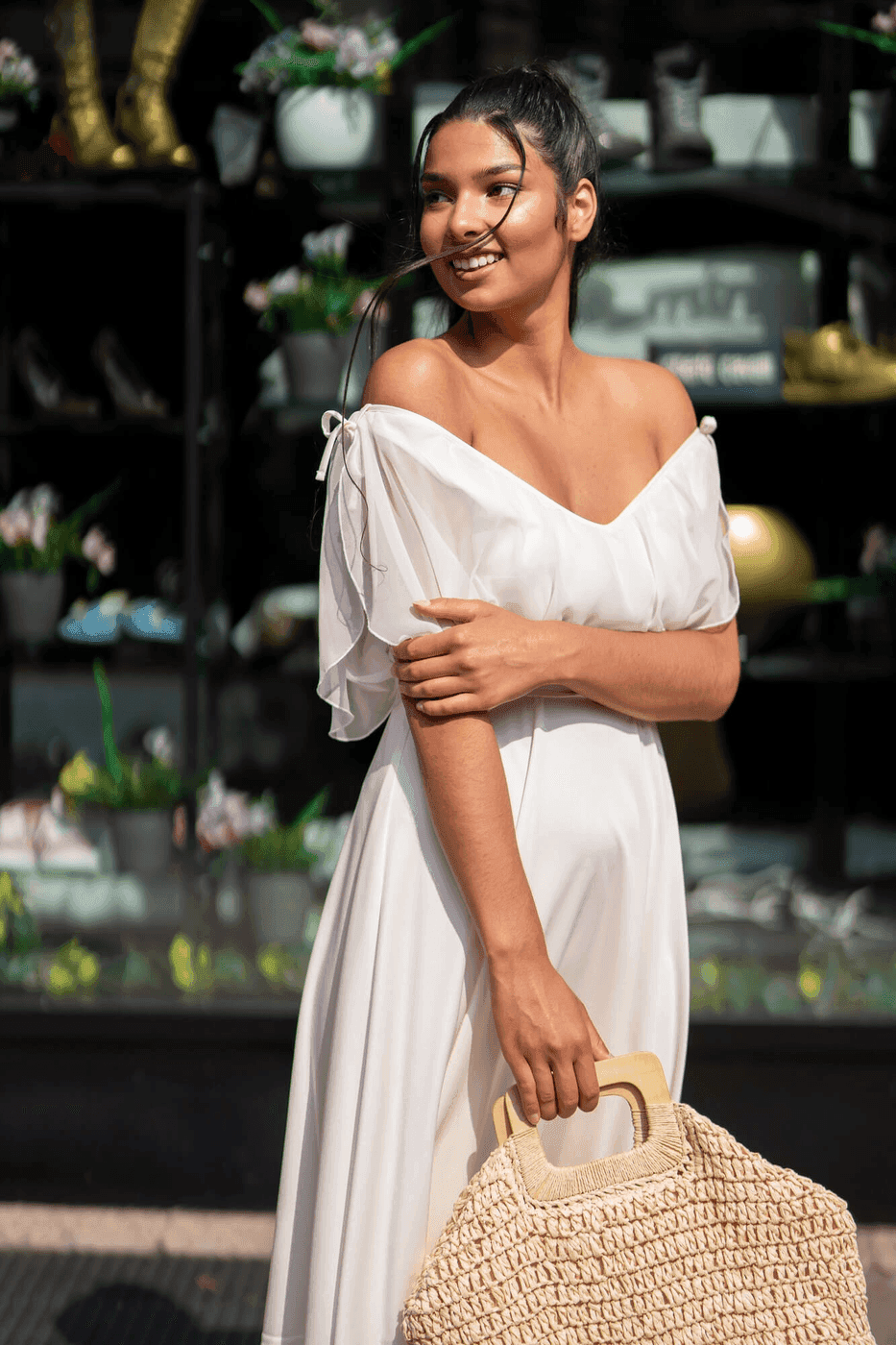 Model in a white off-shoulder dress