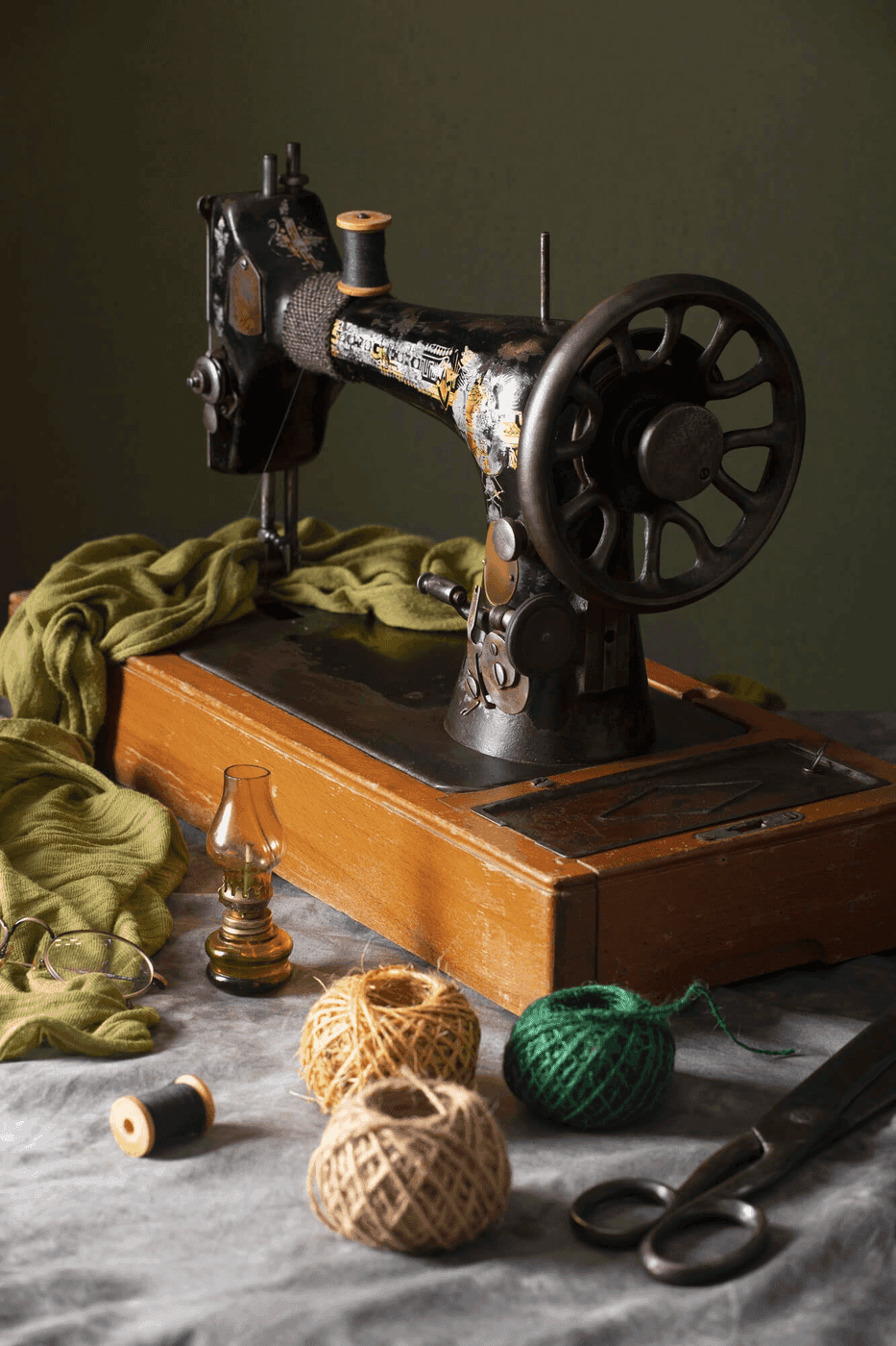 A vintage sewing machine with thread and fabric